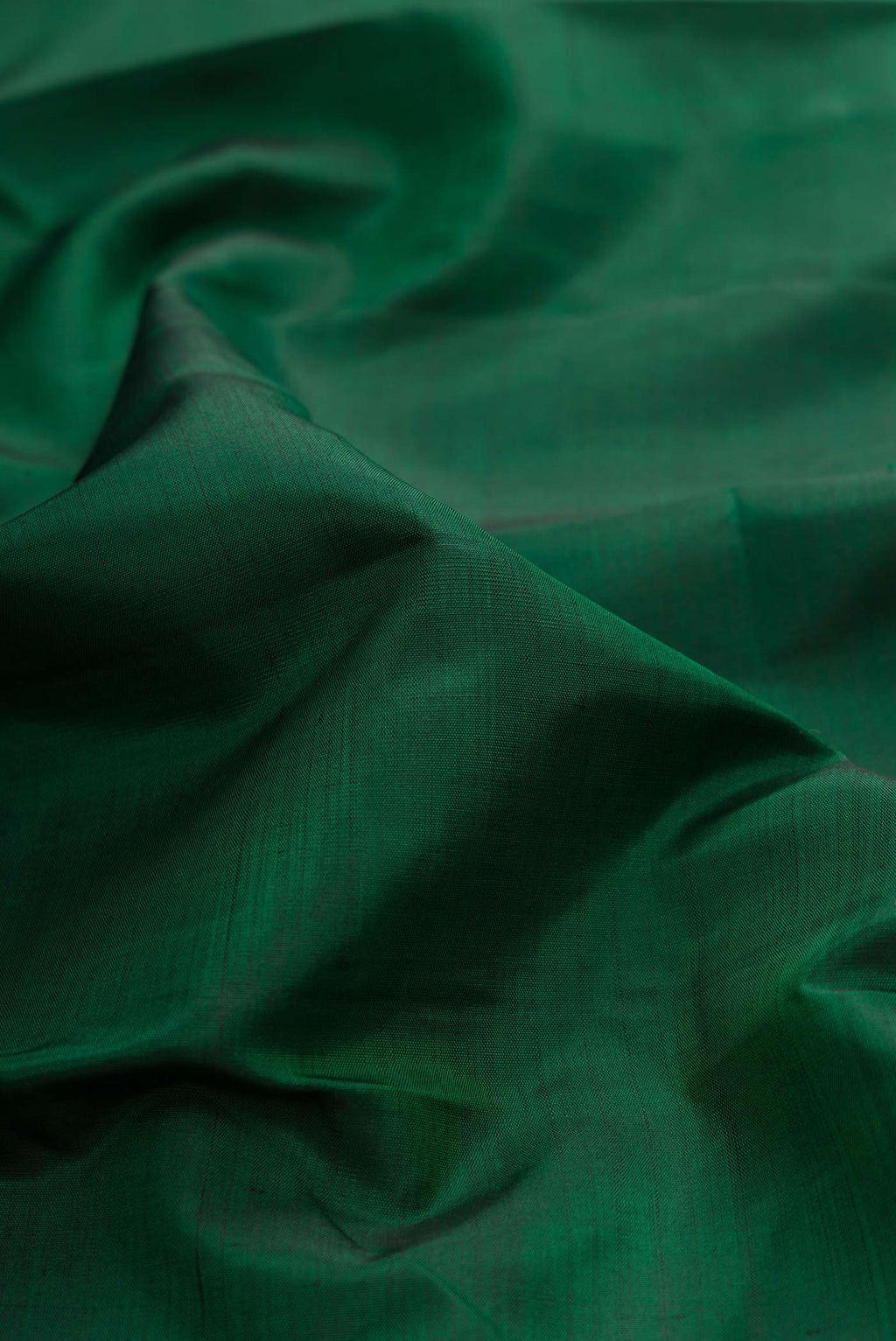 Close up of Bottle Green Dual Tone Kanchipuram Silk Saree with Plain Body and Temple Thread Border displaying folds
