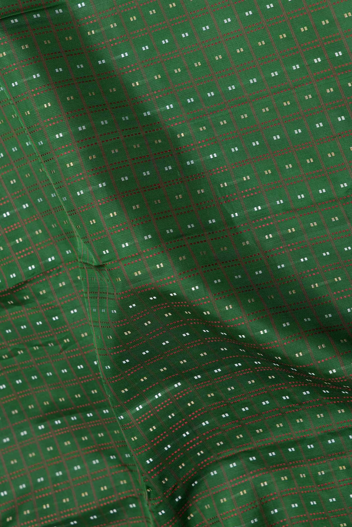 Close up of Green Dual Tone Kanchipuram Saree with Checked design on the body and Zari Border displaying folds