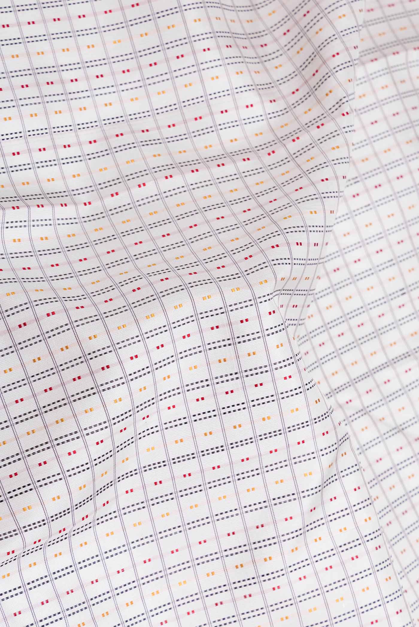 Close up of Off White Dual Tone Kanchipuram Saree with Checked design on the body and Zari Border displaying folds