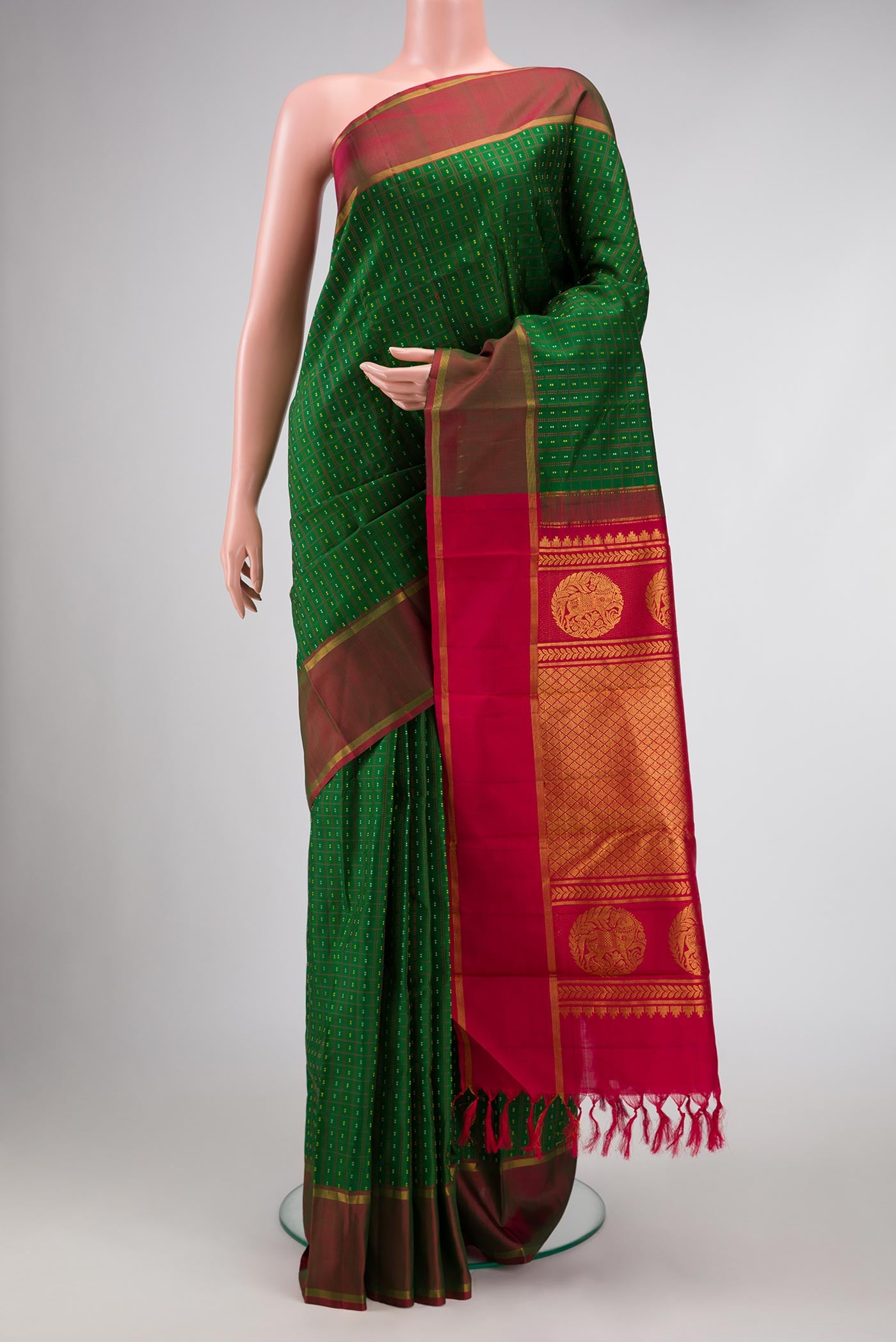 Bottle Green Dual Tone Kanchipuram Silk Saree with Stripes on the body and Zari Border displayed on a mannequin