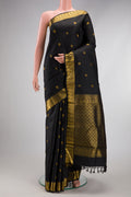 Black Kanjivaram Silk Saree with Zari Butta on the body and Zari Border.  displayed on a mannequin