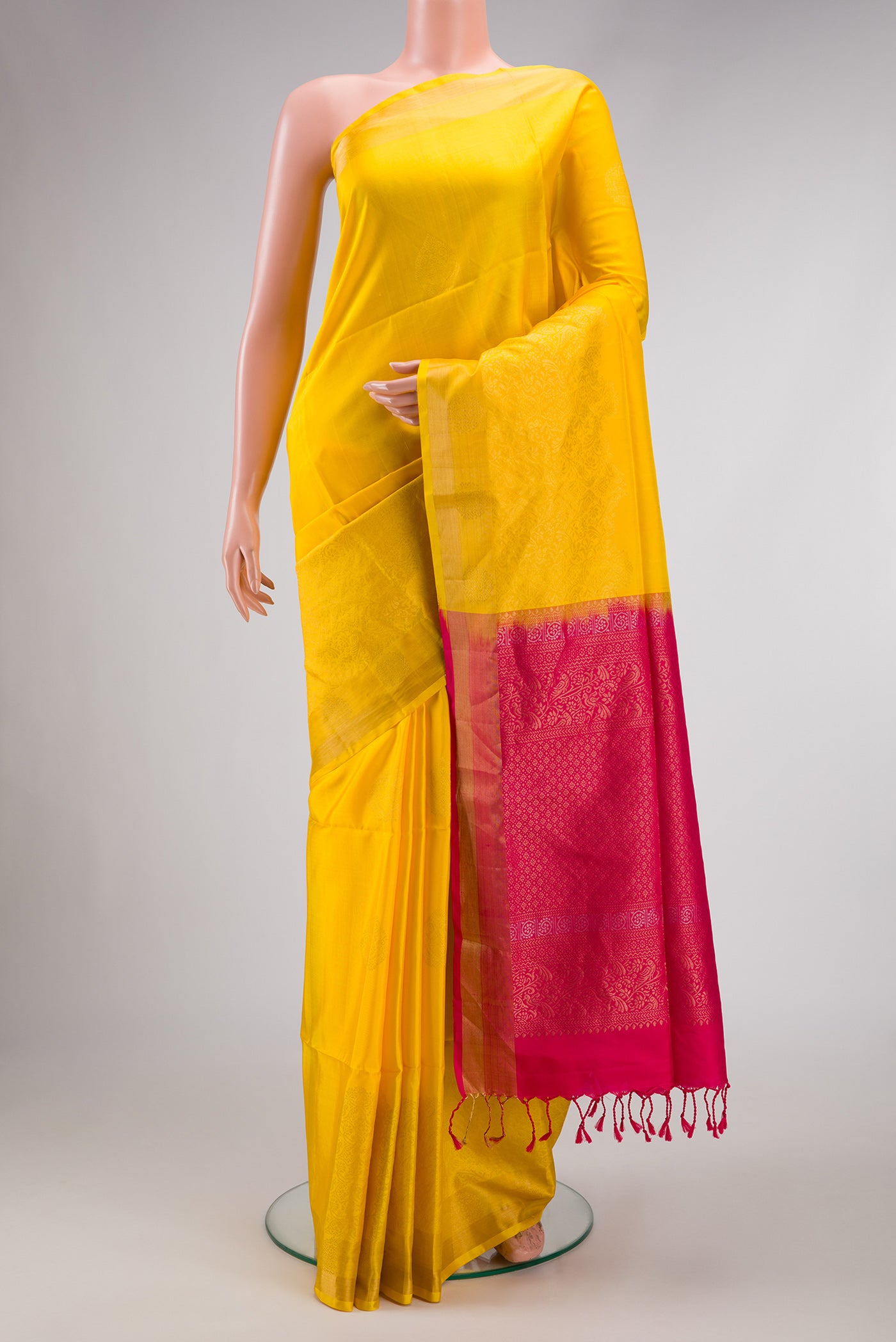 Yellow Dual Tone Soft Silk Saree with Zari Butta on the body and Zari Border.  displayed on a mannequin