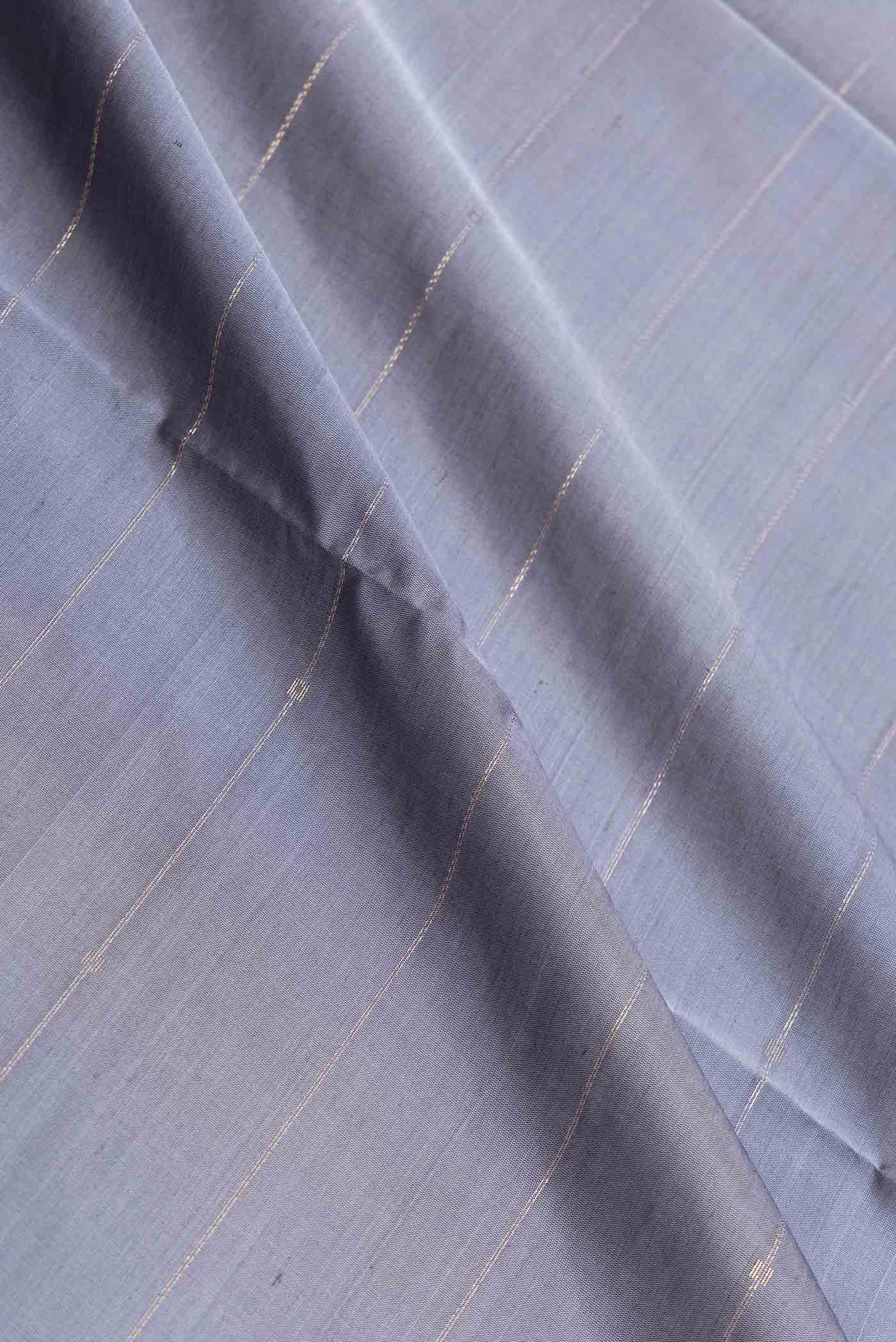 Close up of Grey Dual Tone Soft Silk Saree with Stripes on the body and Zari Border displaying folds
