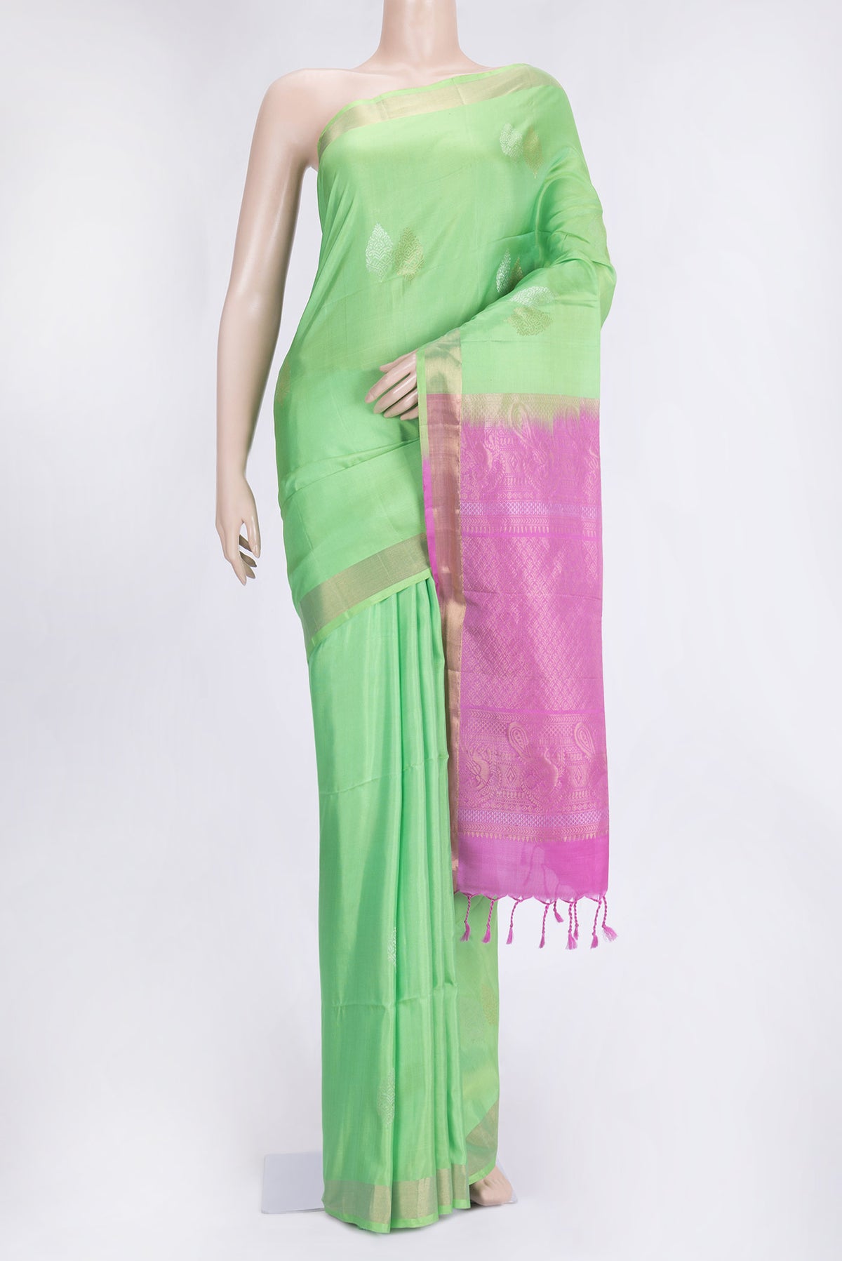 Parrot Green Dual Tone Soft Silk Saree with Zari Butta on the body and Zari Border.  displayed on a mannequin