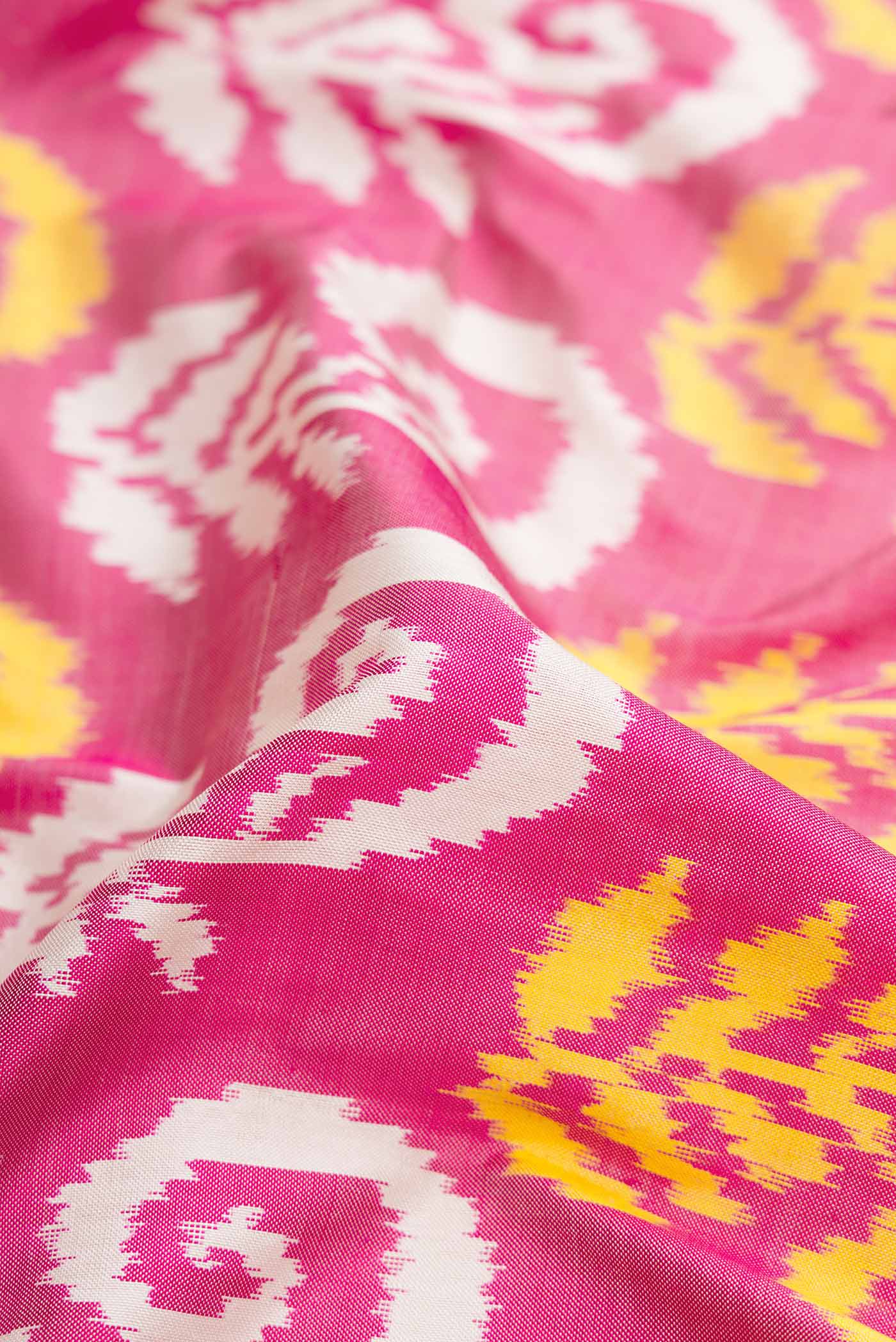 Close up of Rose pink Pochampally Silk Saree with Pure Ikat on the body and Plain Border displaying folds