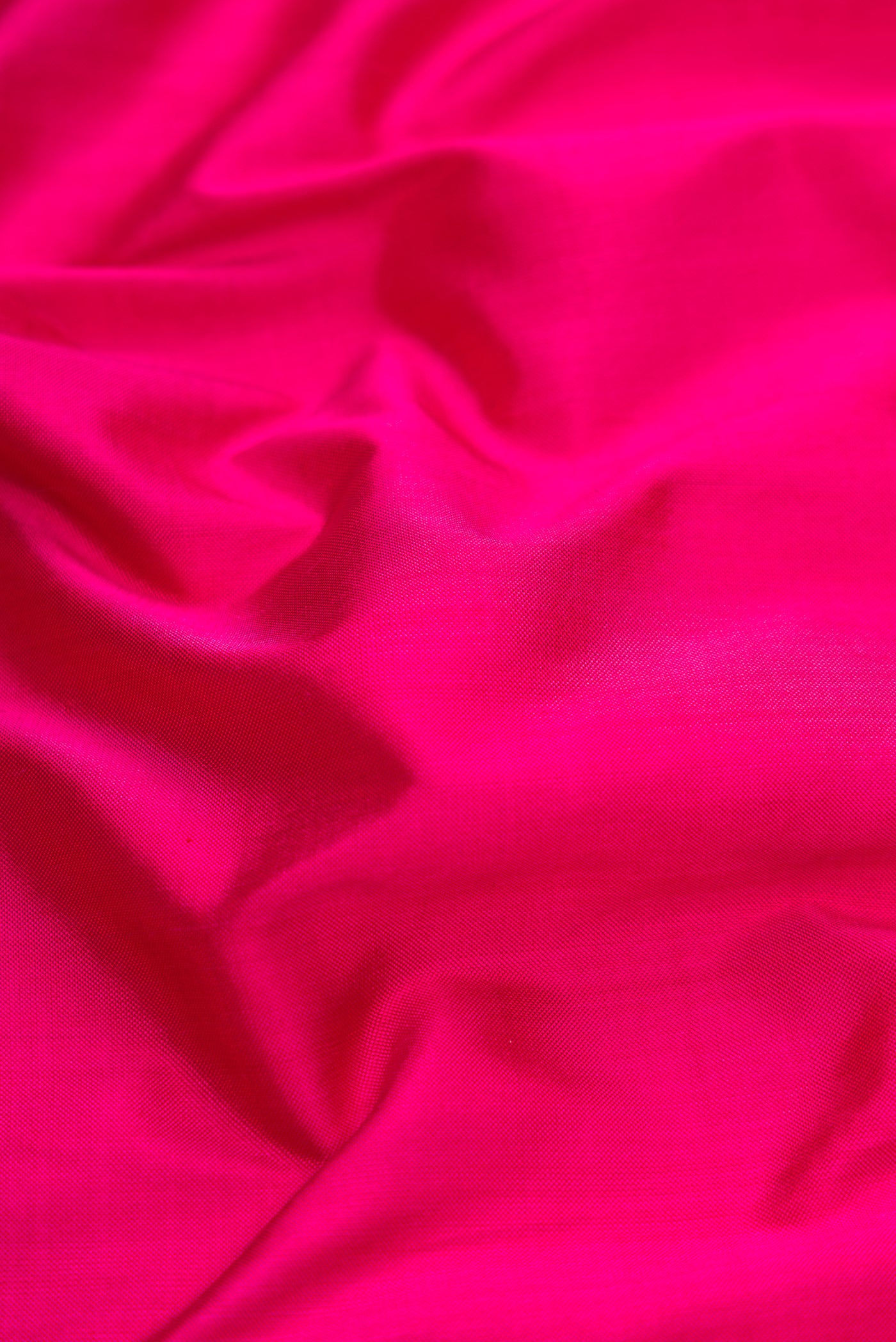 Close up of Pink Dual Tone Double Ikat Saree with Plain Body and Ikat Border.  displaying folds