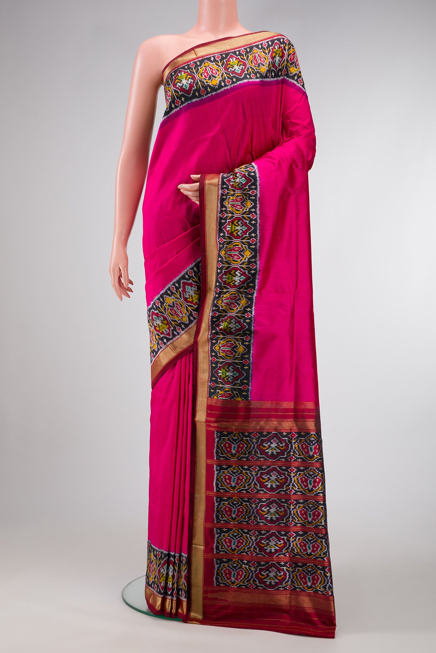 Pink Dual Tone Double Ikat Saree with Plain Body and Ikat Border.  displayed on a mannequin