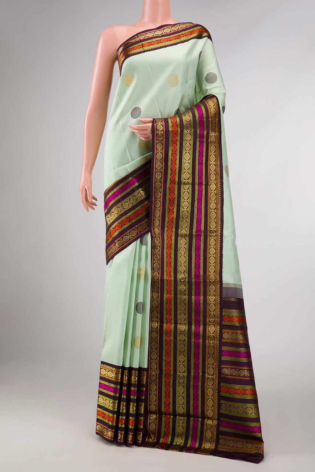 Pure Silk Pure Zari Pista Green Dual Tone Kanchipuram Saree with Zari And Thread Butta on the body and Zari And Thread Border displayed on a mannequin
