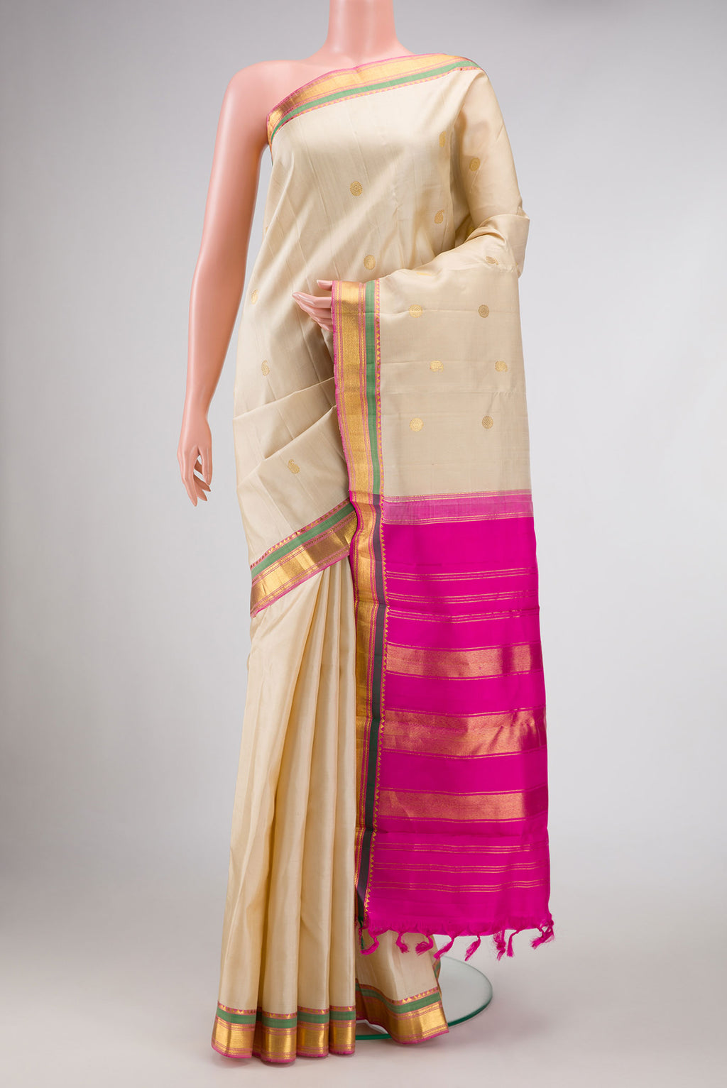 Cream Kanchipuram Silk Saree with Zari Butta on the body and Zari Border displayed on a mannequin