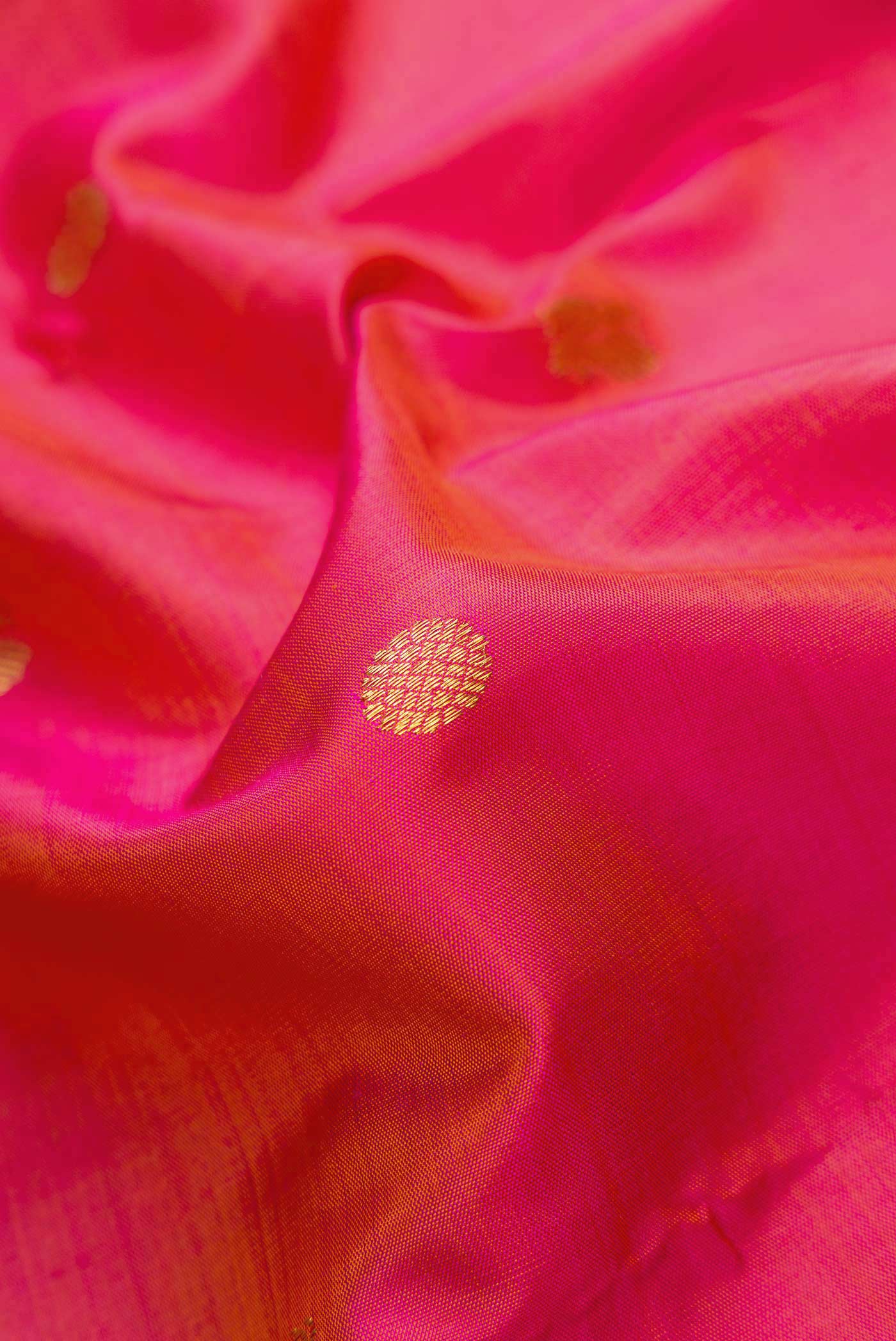 Close up of Pink Dual Tone Kanjivaram Silk Saree with Zari Butta on the body and Zari Border.  displaying folds