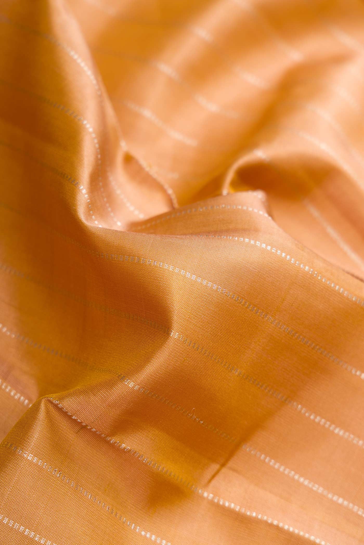 Close up of Gold Dual Tone Kanchipuram Silk Saree with Stripes on the body and Without Border displaying folds