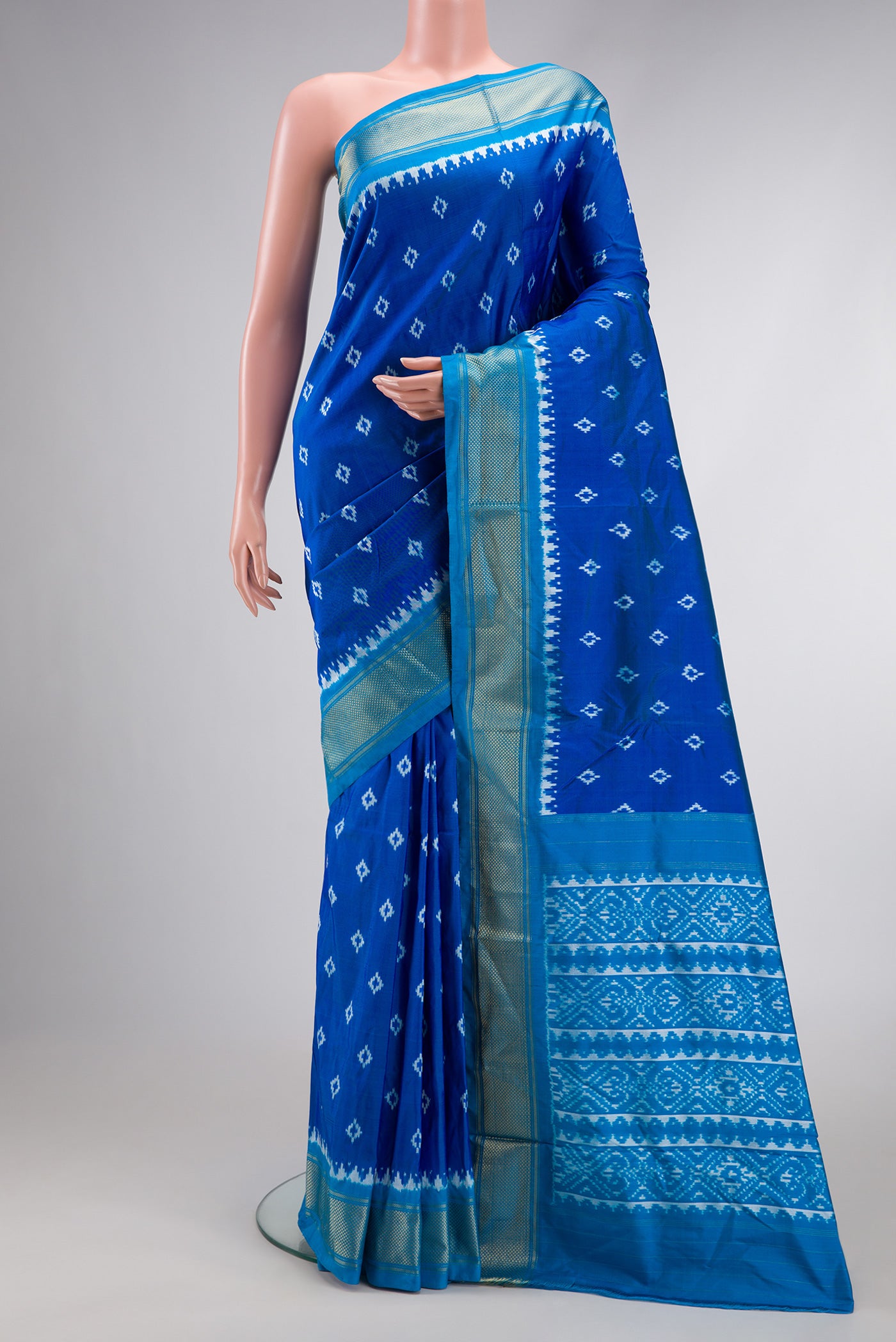 Peacock Blue Dual Tone Double Ikat Nine Yards Saree with Ikat Print on the body and Zari Border.  displayed on a mannequin