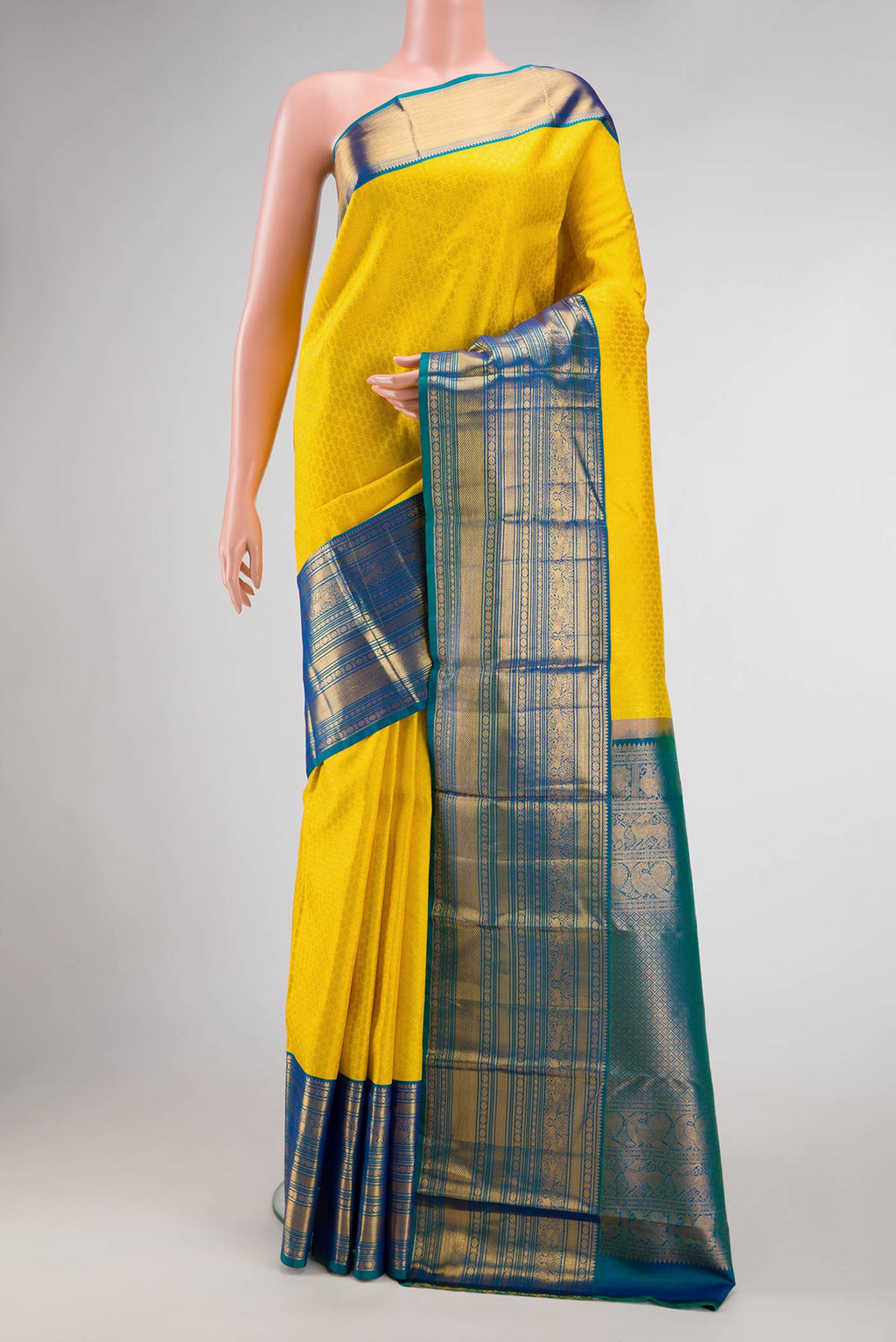 Yellow Dual Tone Kanjivaram Silk Saree with Zari Brocade on the body and Zari Border.  displayed on a mannequin