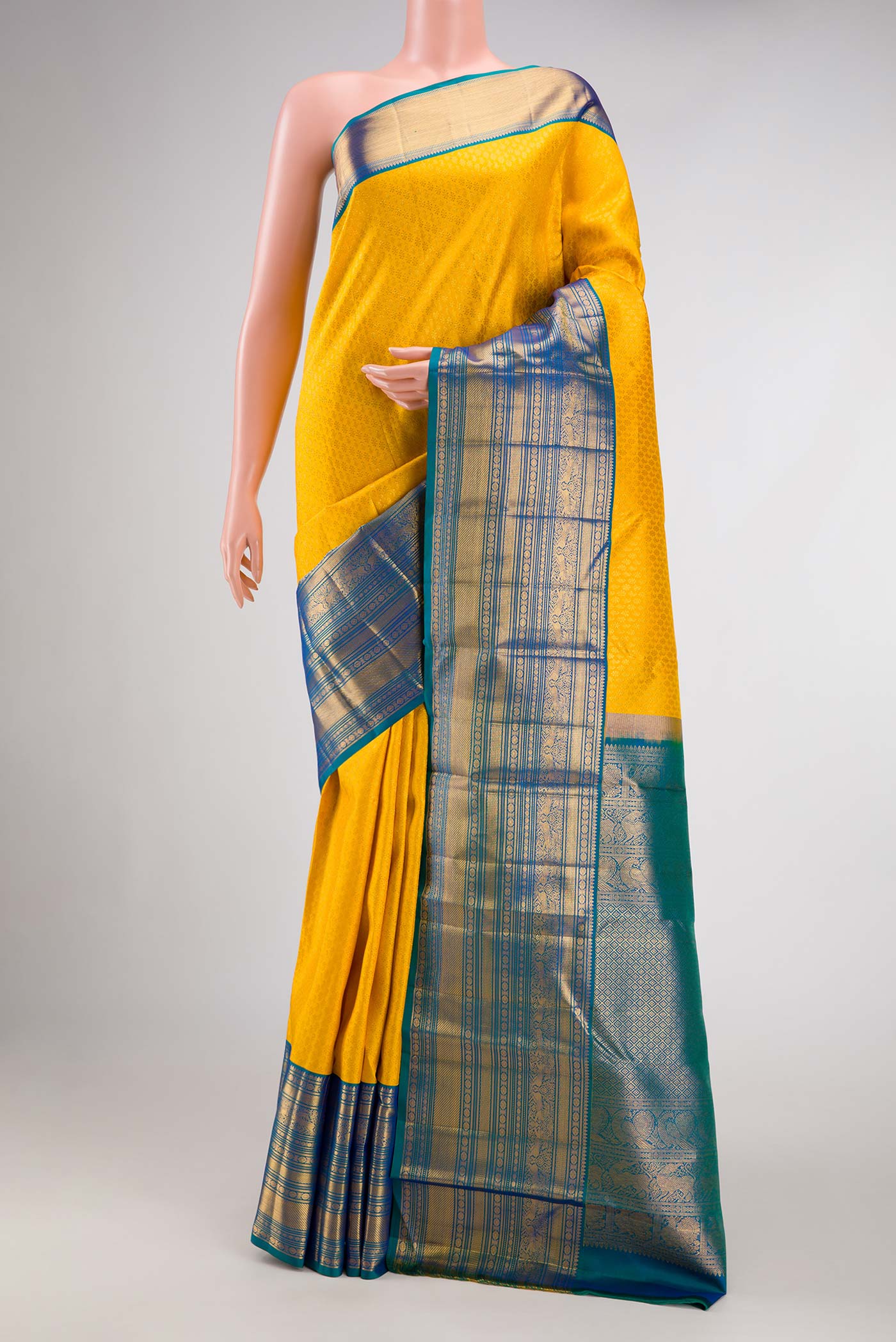 Yellow Dual Tone Kanjivaram Silk Saree with Zari Brocade on the body and Zari Border.  displayed on a mannequin