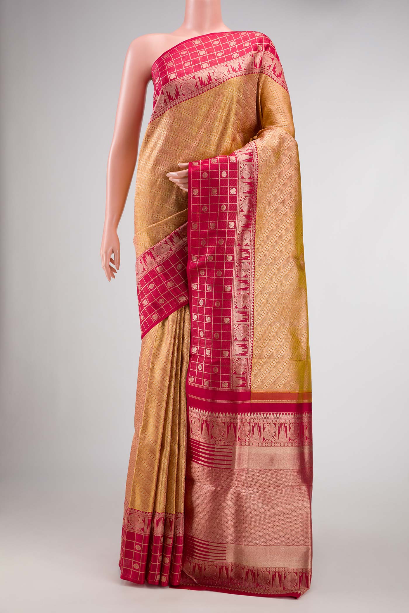 Gold Dual Tone Kanjivaram Tissue Silk Saree with Zari Brocade on the body and Fancy Border.  displayed on a mannequin