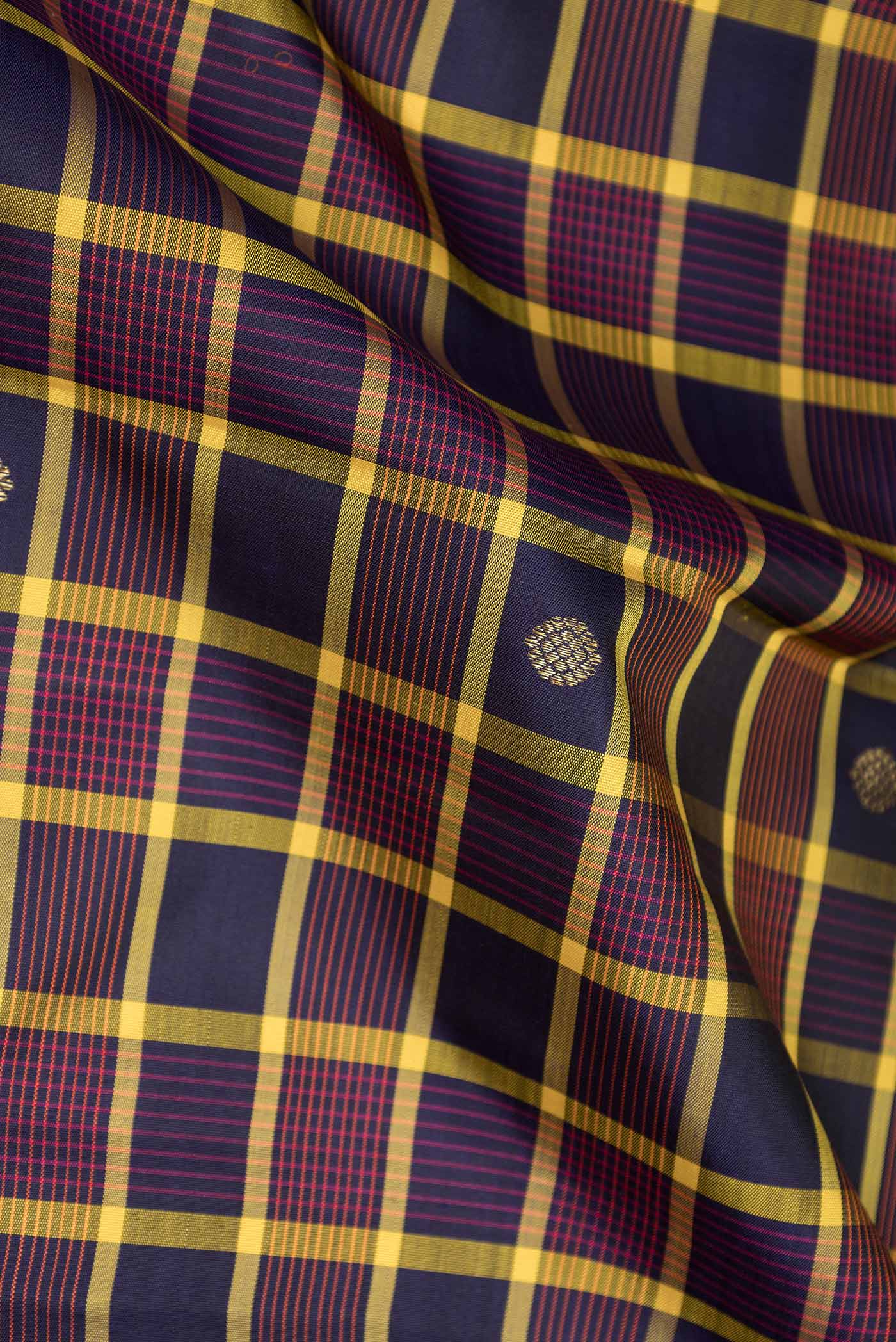 Close up of Pure Silk Pure Zari Burgundy Dual Tone Kanchipuram Saree with Checked design on the body and Zari Border displaying folds
