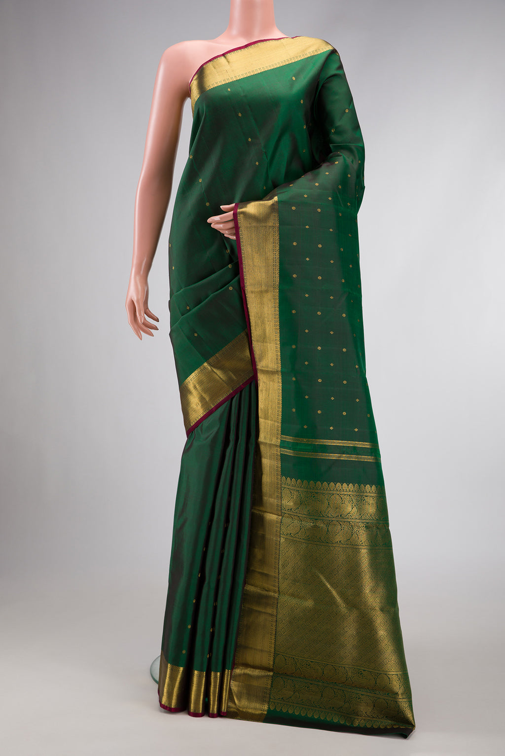 Pure Silk Pure Zari Green Dual Tone Kanjivaram Saree with Zari Butta on the body and Zari Border.  displayed on a mannequin