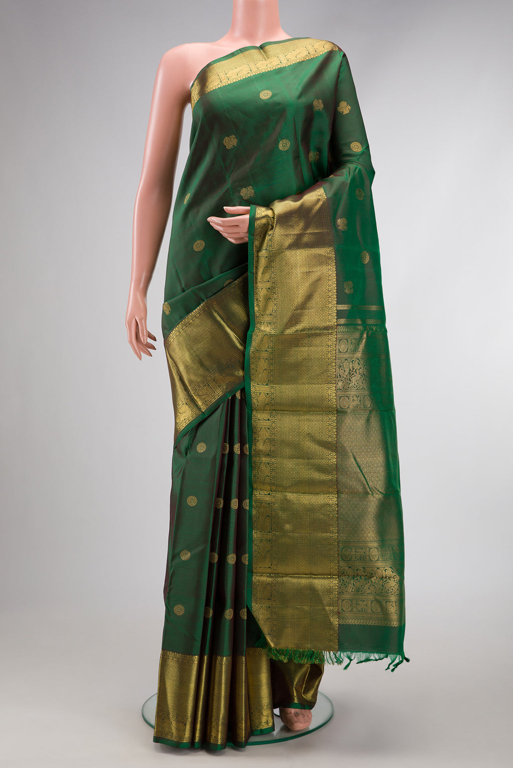 Pure Silk Pure Zari Green Kanjivaram Saree with Zari Butta on the body and Zari Border.  displayed on a mannequin