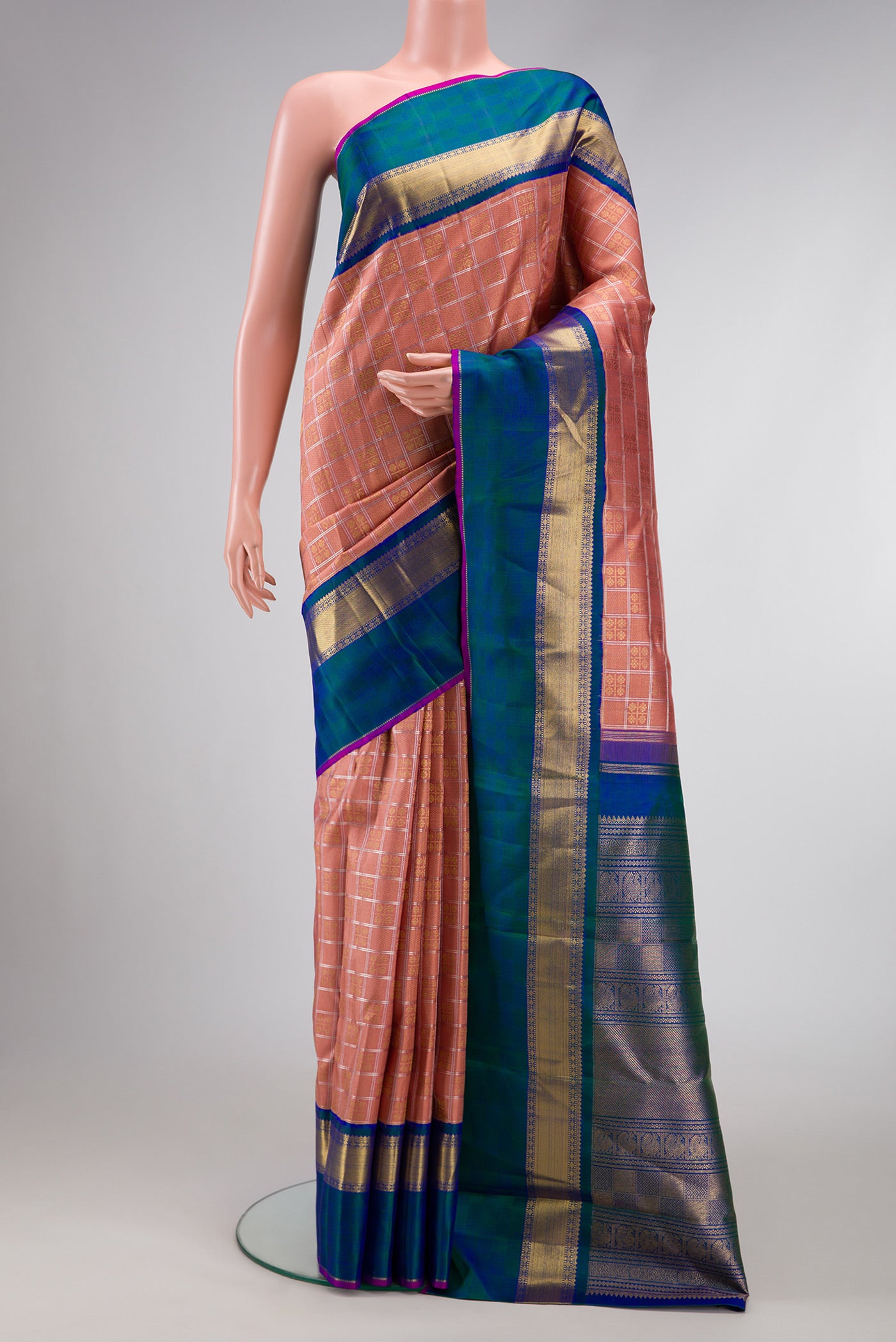 Pure Silk Pure Zari Rose Gold Dual Tone Kanjivaram Saree with Checked design on the body and Zari Border.  displayed on a mannequin