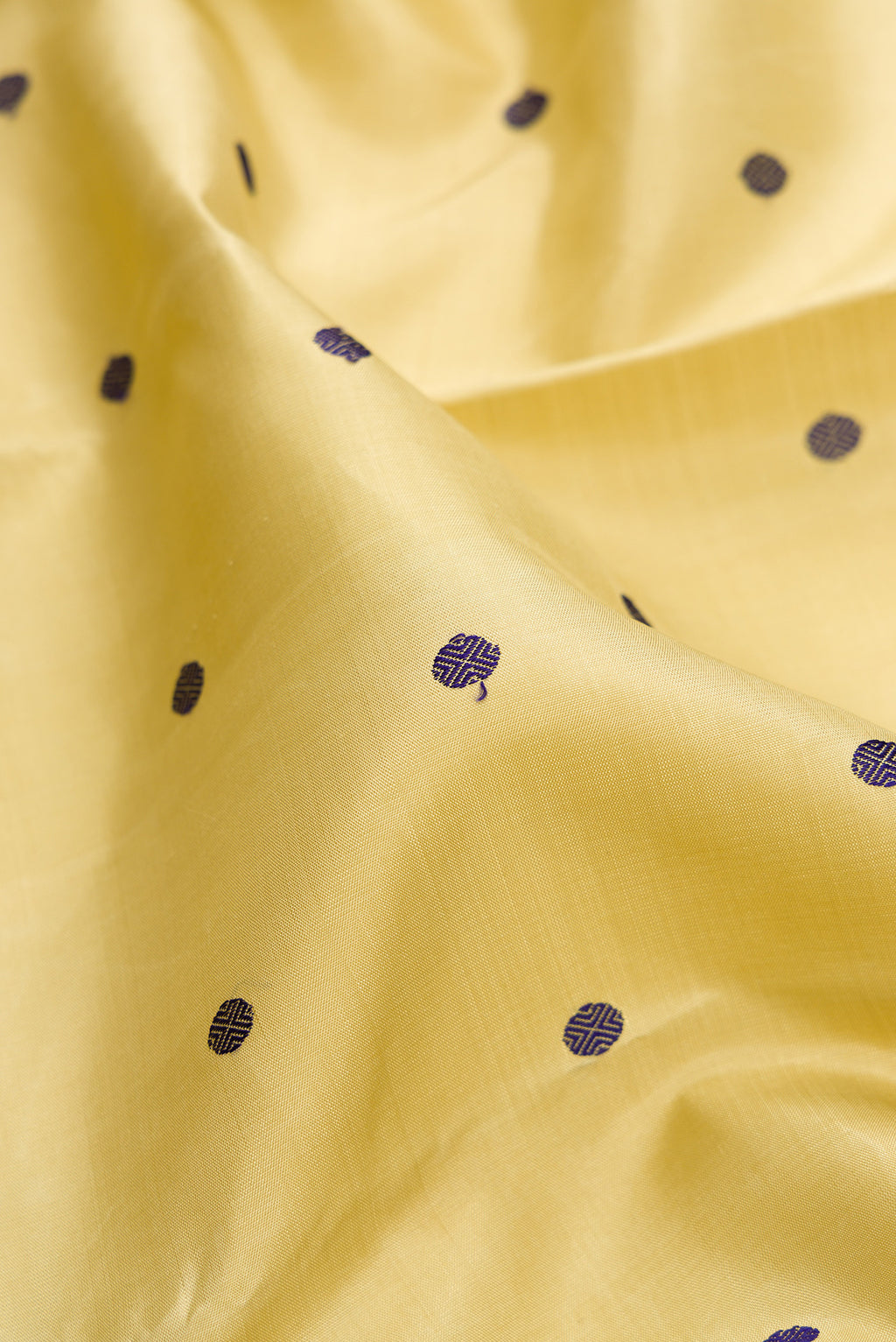 Close up of Pure Silk Pure Zari Sandal Kanjivaram Saree with Thread Butta on the body and Zari Border.  displaying folds