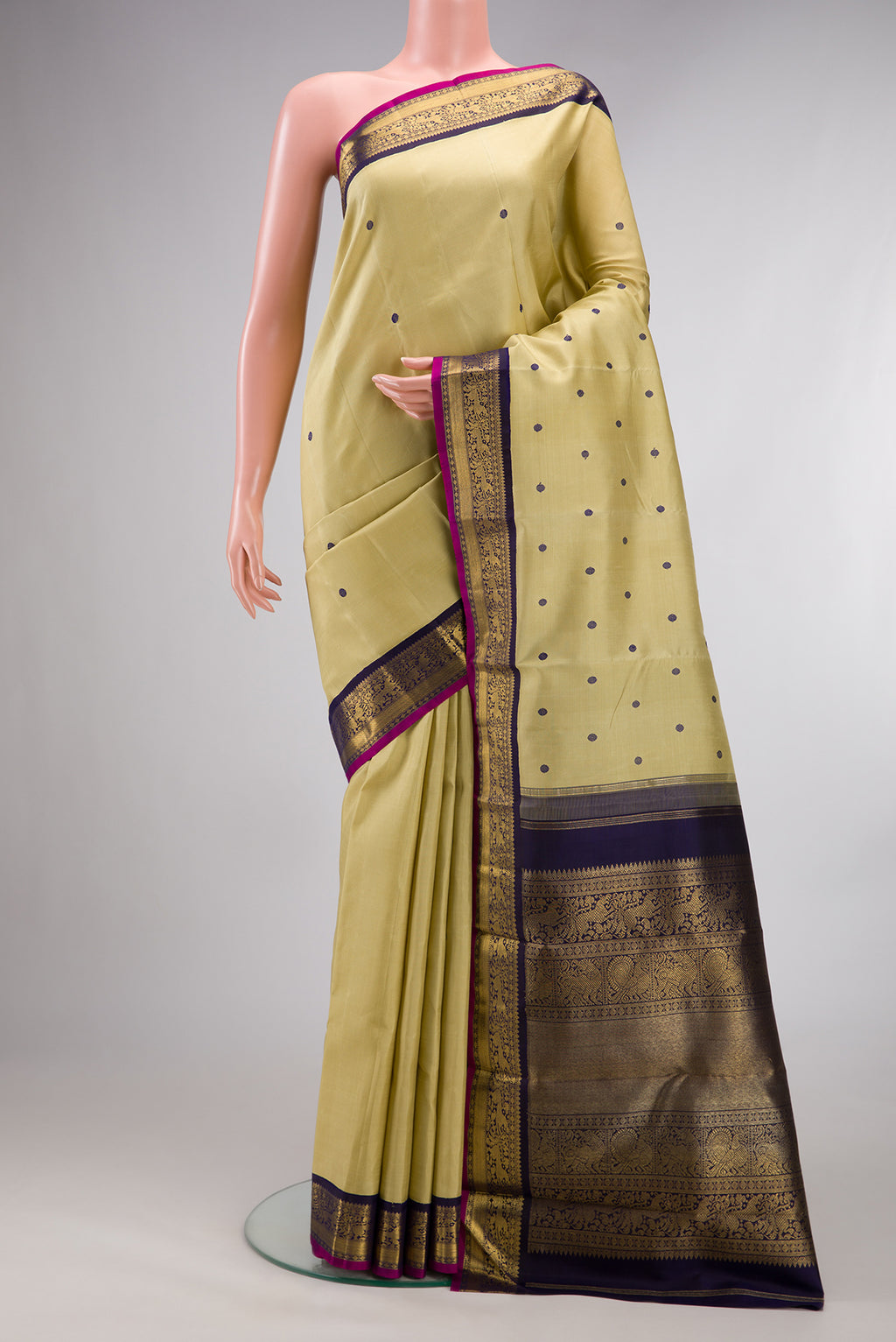 Pure Silk Pure Zari Sandal Kanjivaram Saree with Thread Butta on the body and Zari Border.  displayed on a mannequin