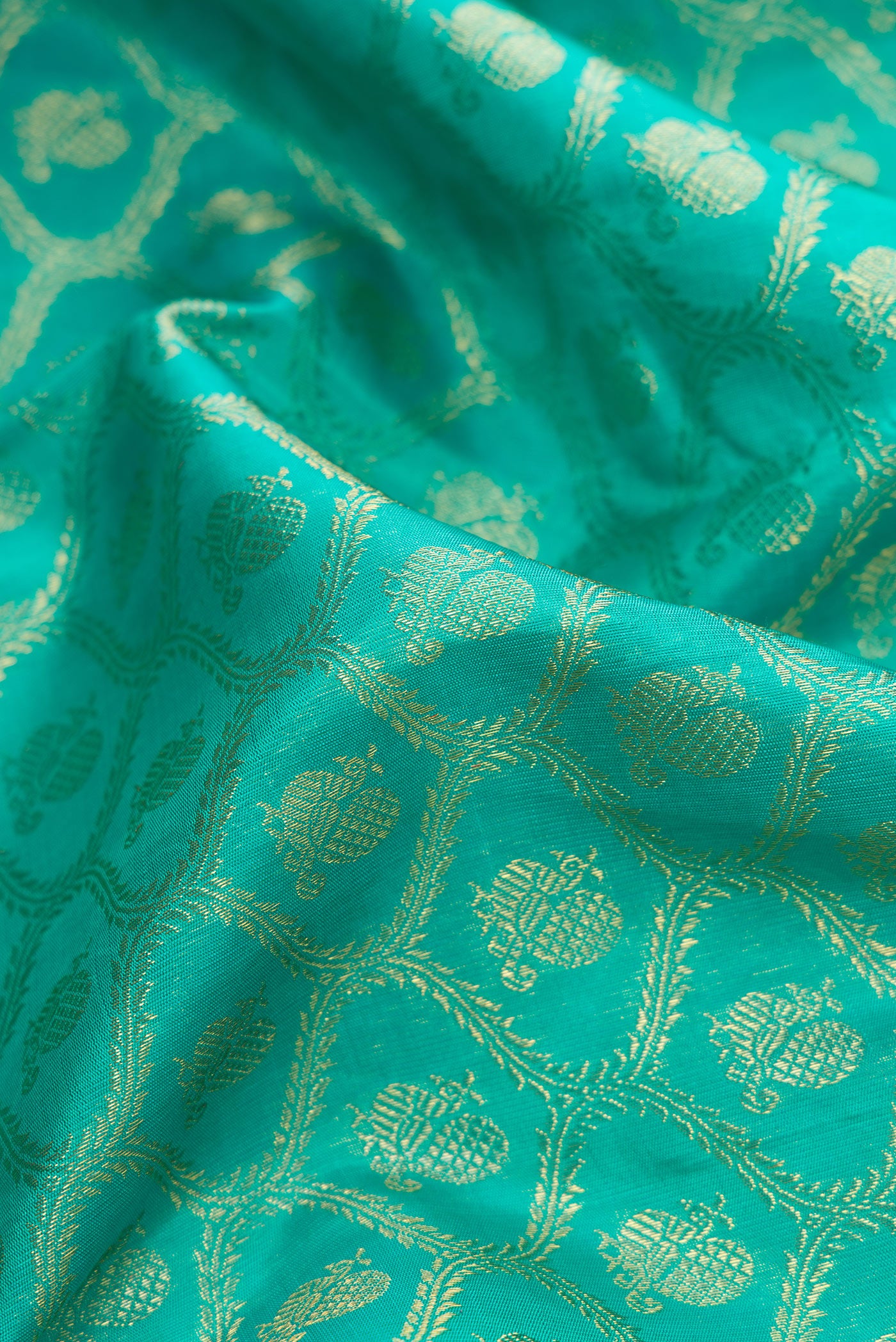 Close up of Pure Silk Pure Zari Sea Green Dual Tone Kanjivaram Saree with Zari Brocade on the body and Zari Border.  displaying folds