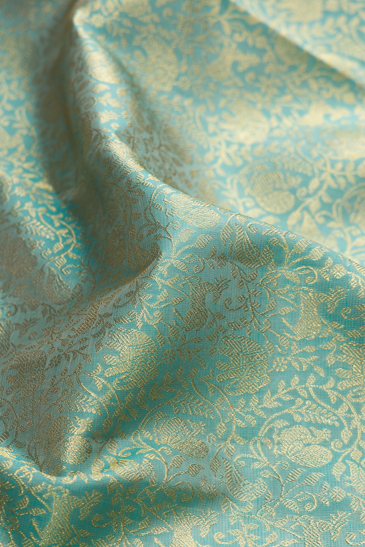 Close up of Pure Silk Pure Zari Light Blue Dual Tone Kanjivaram Saree with Zari Brocade on the body and Zari Border.  displaying folds