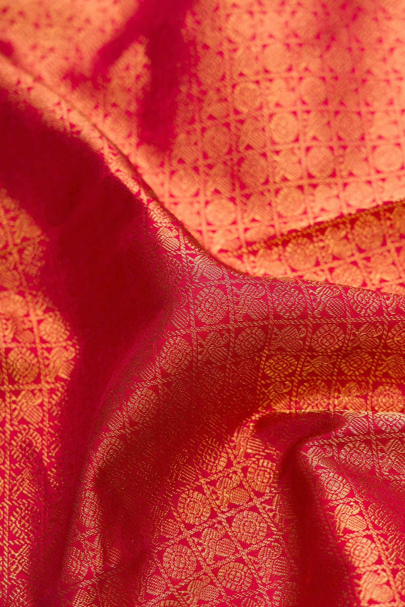 Close up of Pure Silk Pure Zari Red Dual Tone Kanjivaram Saree with Zari Brocade on the body and Zari Border.  displaying folds