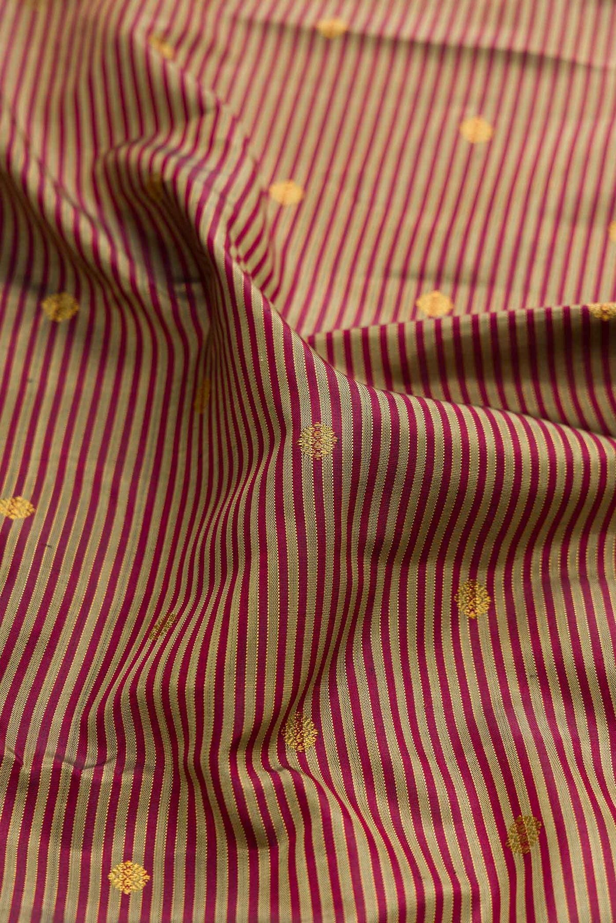 Close up of Pure Silk Pure Zari Brown Dual Tone Kanchipuram Saree with Stripes on the body and Zari Border displaying folds