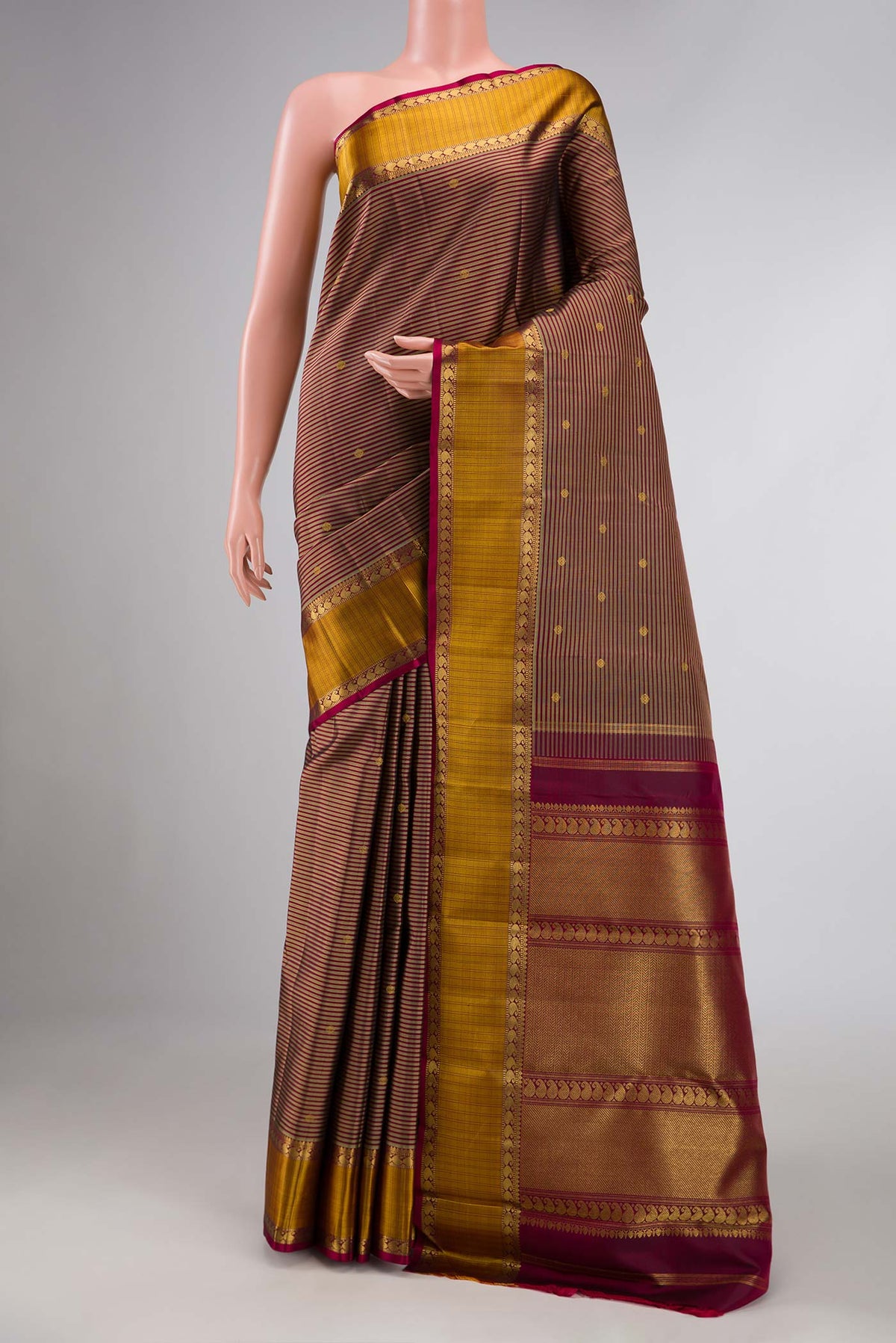 Pure Silk Pure Zari Brown Dual Tone Kanchipuram Saree with Stripes on the body and Zari Border displayed on a mannequin