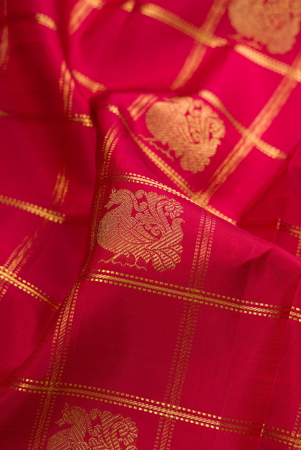 Close up of Pure Silk Pure Zari Maroon Kanjivaram Saree with Checked design on the body and Fancy Border.  displaying folds
