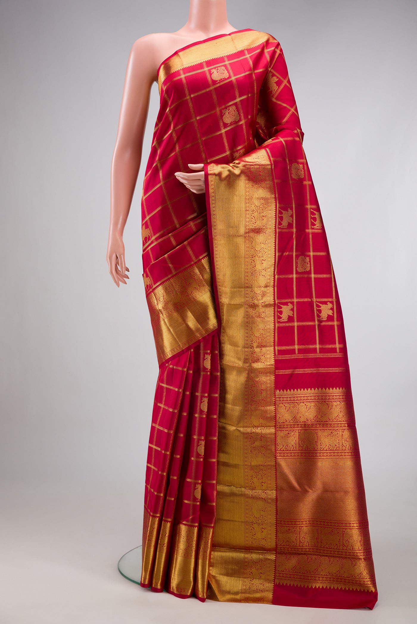 Pure Silk Pure Zari Maroon Kanjivaram Saree with Checked design on the body and Fancy Border.  displayed on a mannequin