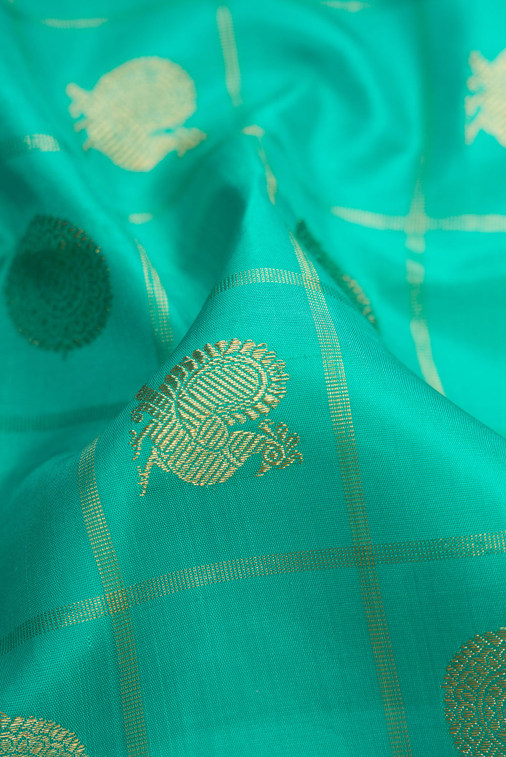 Close up of Pure Silk Pure Zari Sea Green Dual Tone Kanjivaram Saree with Checked design on the body and Zari Border.  displaying folds