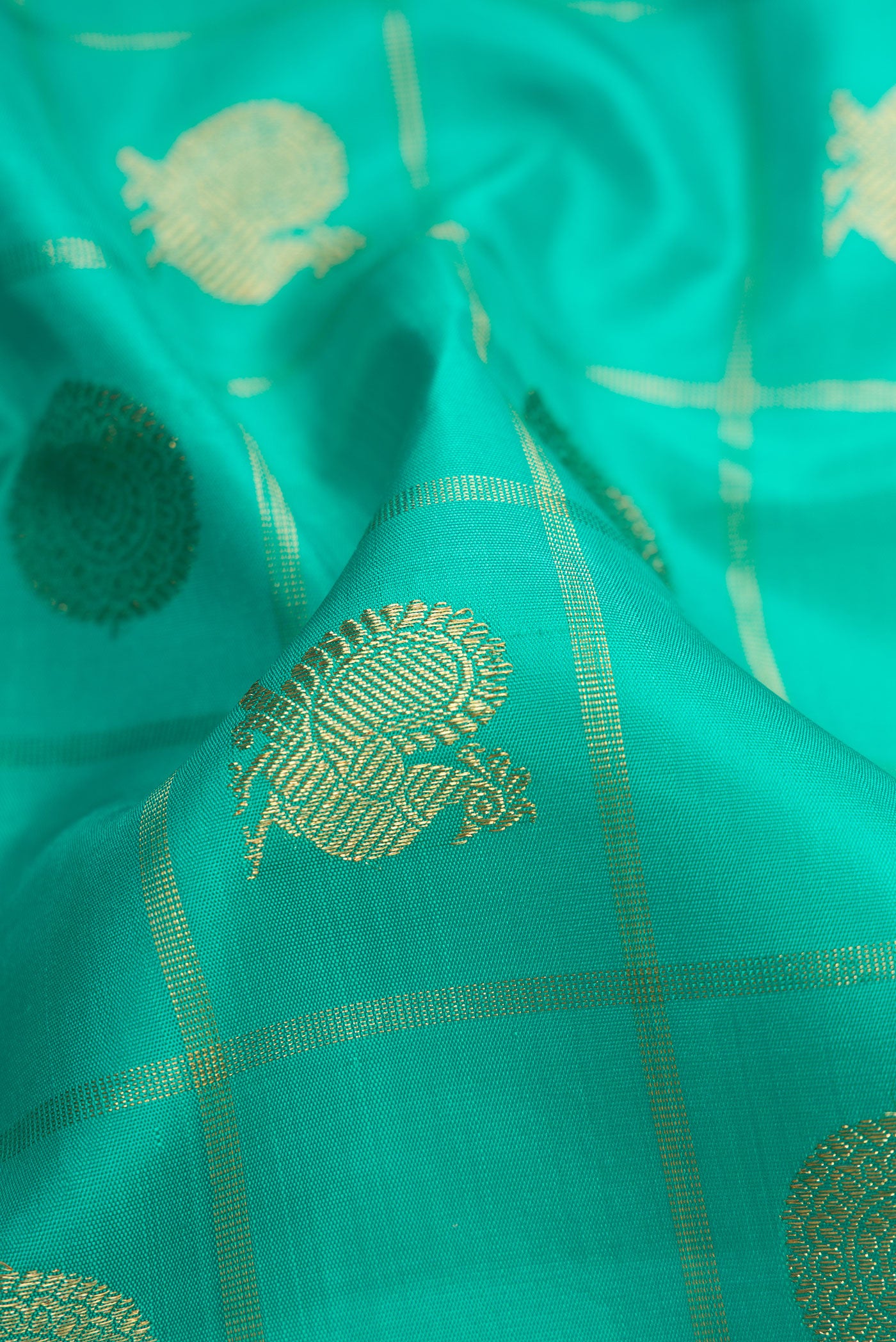 Close up of Pure Silk Pure Zari Sea Green Dual Tone Kanjivaram Saree with Checked design on the body and Zari Border.  displaying folds