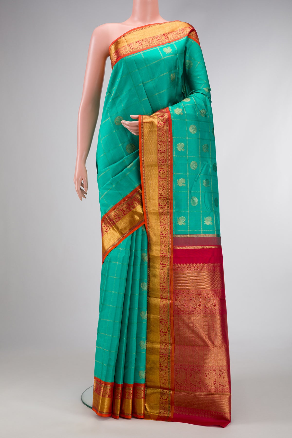 Pure Silk Pure Zari Sea Green Dual Tone Kanjivaram Saree with Checked design on the body and Zari Border.  displayed on a mannequin