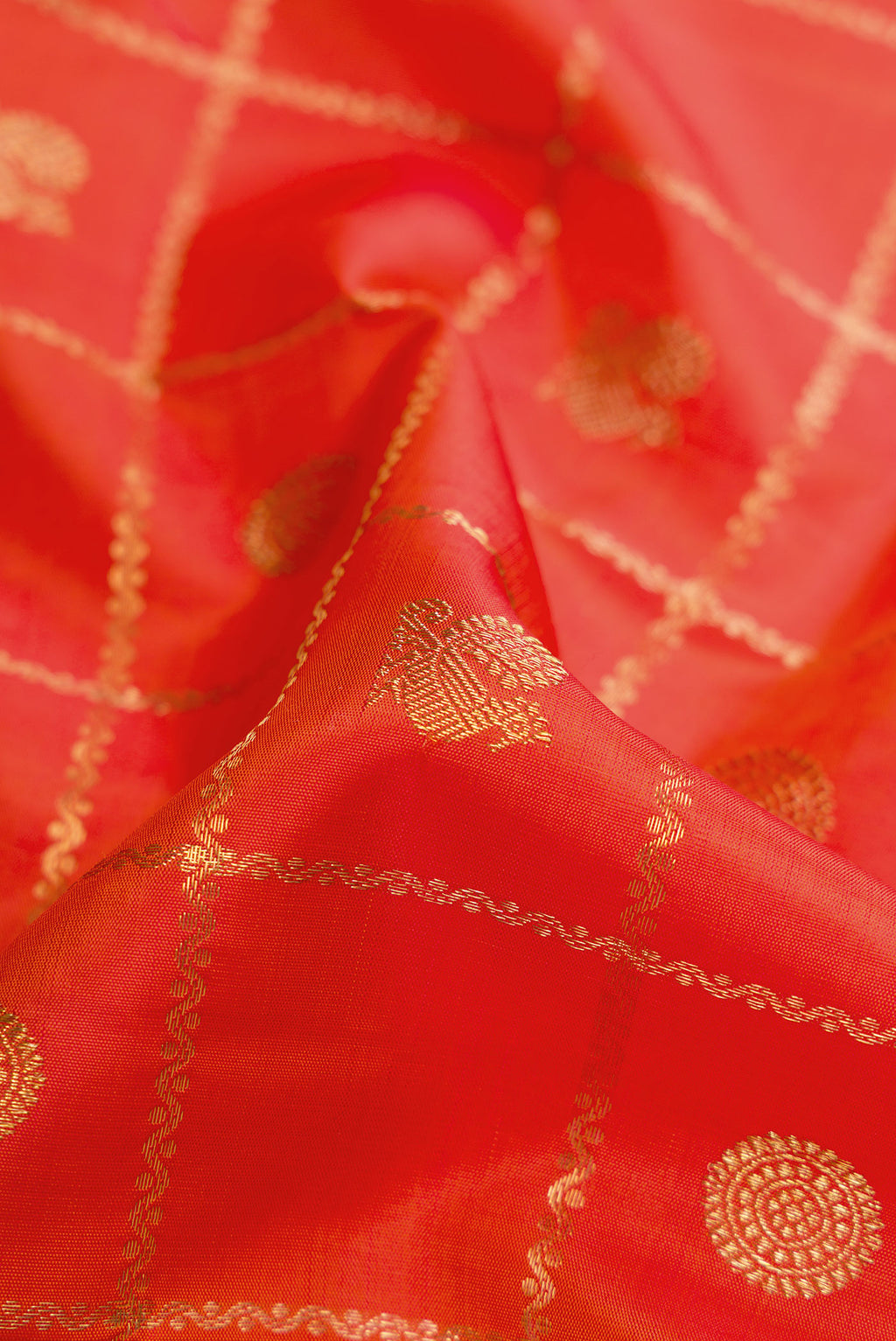 Close up of Pure Silk Pure Zari Orange Dual Tone Kanjivaram Saree with Checked design on the body and Zari Border.  displaying folds
