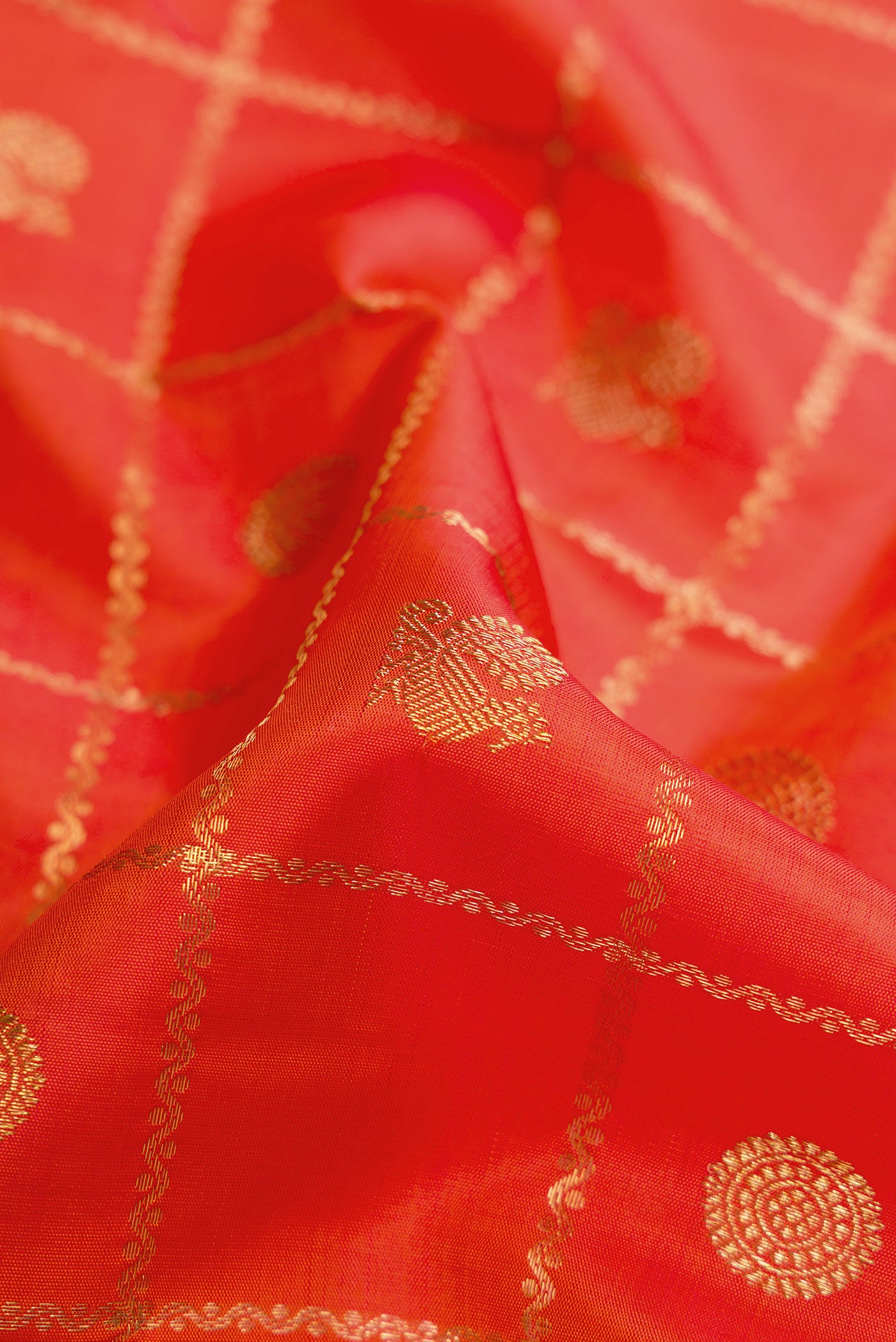 Close up of Pure Silk Pure Zari Orange Dual Tone Kanjivaram Saree with Checked design on the body and Zari Border.  displaying folds