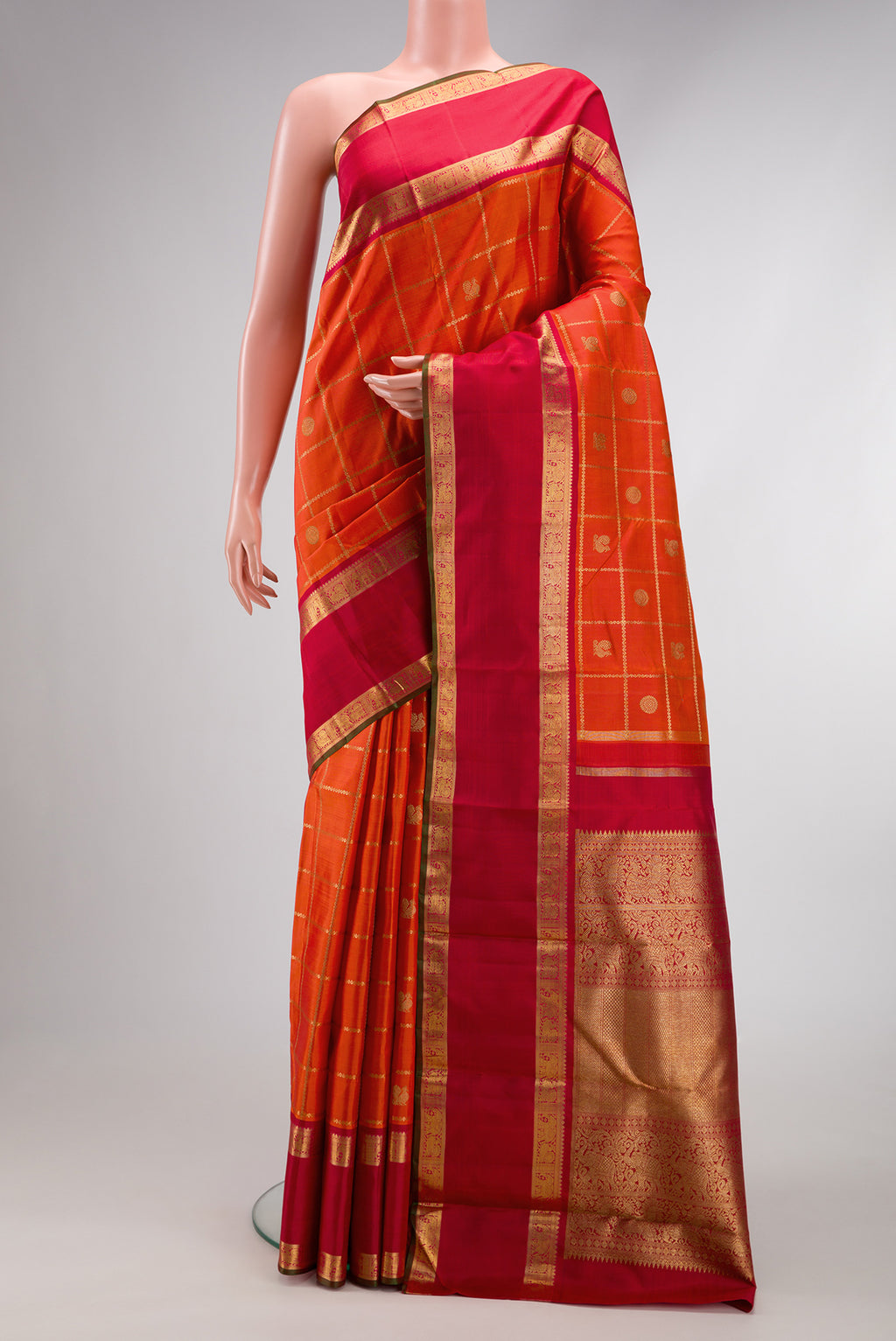Pure Silk Pure Zari Orange Dual Tone Kanjivaram Saree with Checked design on the body and Zari Border.  displayed on a mannequin