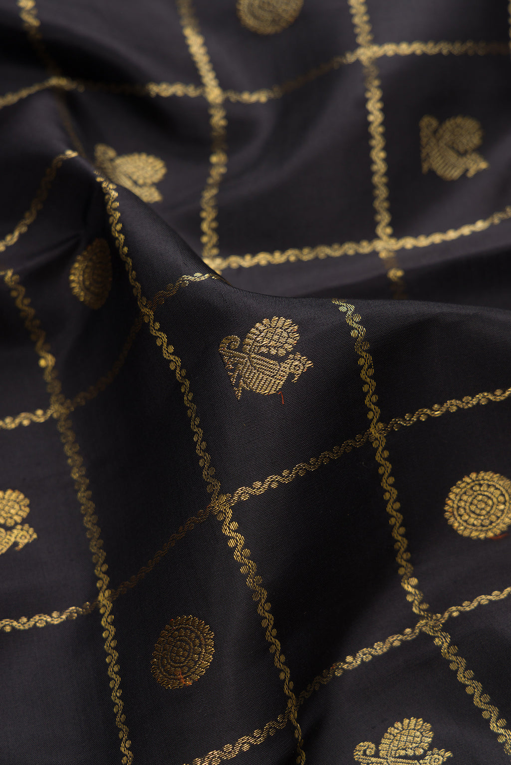Close up of Pure Silk Pure Zari Black Kanjivaram Saree with Checked design on the body and Zari Border.  displaying folds