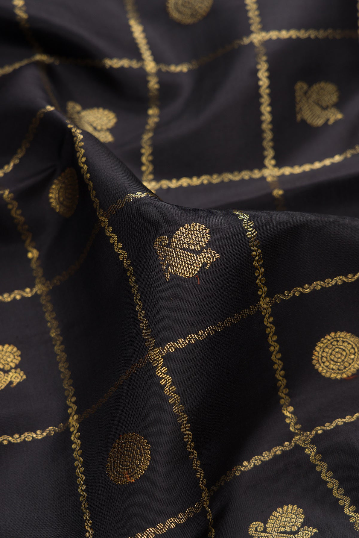 Close up of Pure Silk Pure Zari Black Kanjivaram Saree with Checked design on the body and Zari Border.  displaying folds