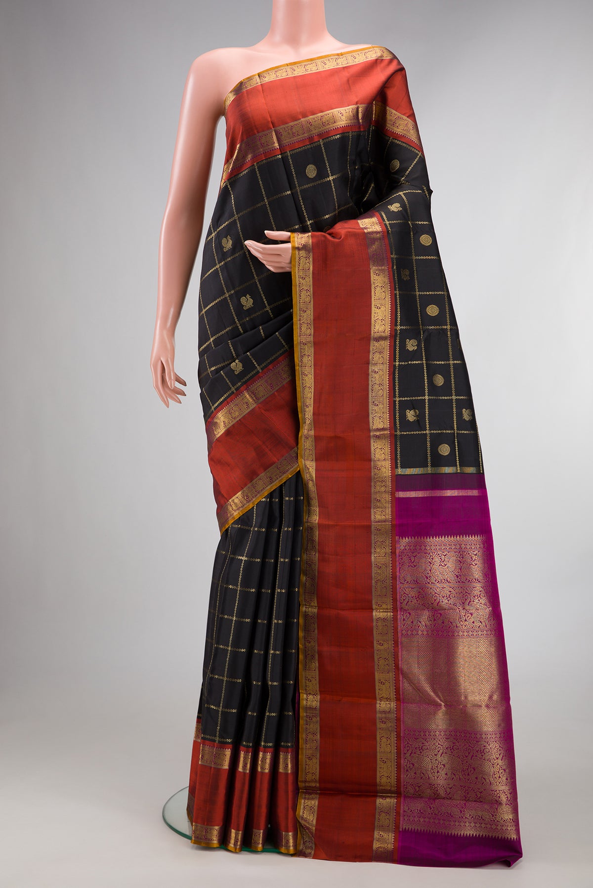 Pure Silk Pure Zari Black Kanjivaram Saree with Checked design on the body and Zari Border.  displayed on a mannequin