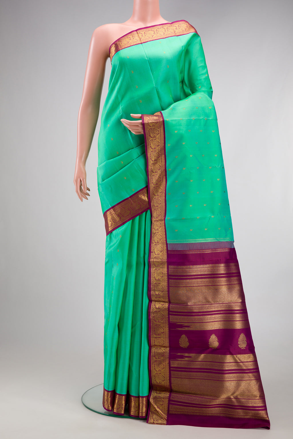 Pure Silk Pure Zari Sea Green Kanjivaram Saree with Zari Butta on the body and Zari Border.  displayed on a mannequin