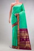 Pure Silk Pure Zari Sea Green Kanjivaram Saree with Zari Butta on the body and Zari Border.  displayed on a mannequin
