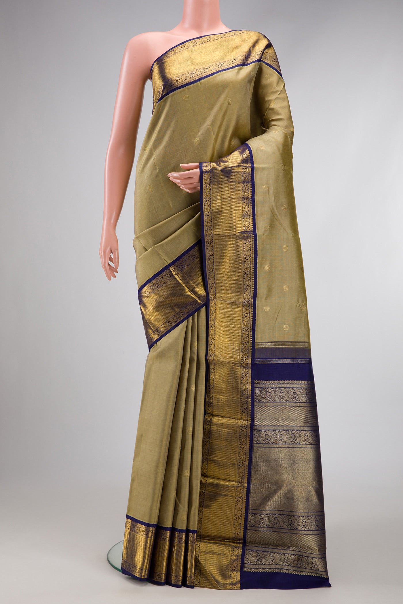 Pure Silk Pure Zari Dark Beige Kanjivaram Saree with Zari Butta on the body and Zari Border.  displayed on a mannequin