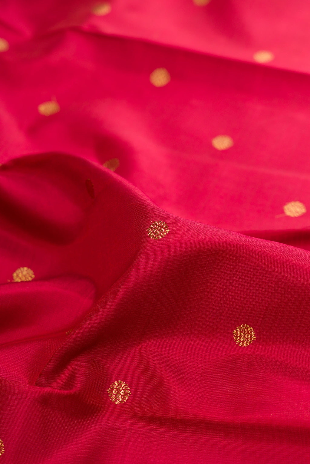 Close up of Pure Silk Pure Zari Maroon Kanjivaram Saree with Zari Butta on the body and Zari Border.  displaying folds