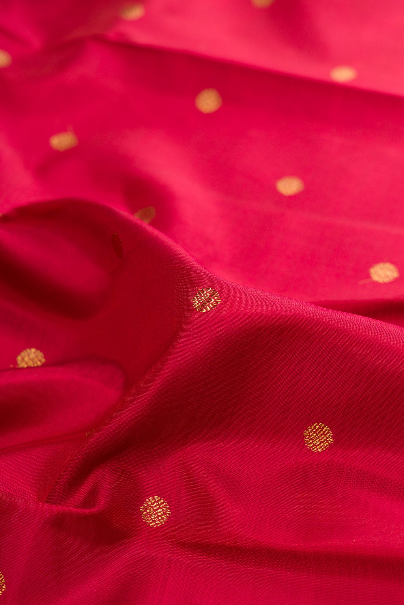 Close up of Pure Silk Pure Zari Maroon Kanjivaram Saree with Zari Butta on the body and Zari Border.  displaying folds