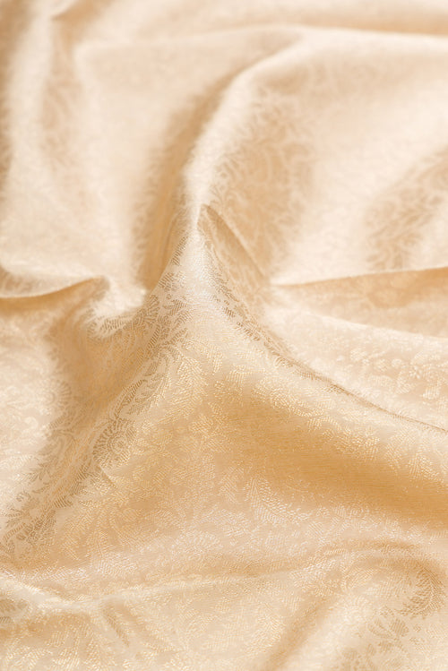Close up of Beige Kanchipuram Silk Saree with Zari Brocade on the body and Zari Border.  displaying folds