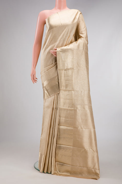 Beige Kanchipuram Silk Saree with Zari Brocade on the body and Zari Border.  displayed on a mannequin