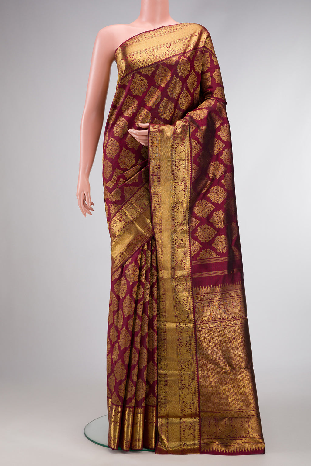 Pure Silk Pure Zari Maroon Dual Tone Kanjivaram Saree with Zari Brocade on the body and Zari Border.  displayed on a mannequin