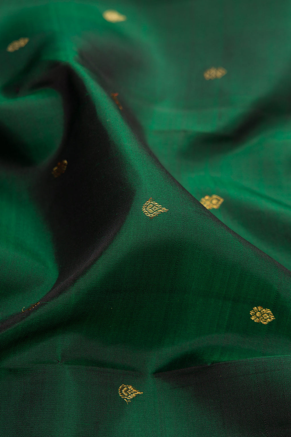 Close up of Pure Silk Pure Zari Bottle Green Kanchipuram Saree with Zari Butta on the body and Fancy Border.  displaying folds